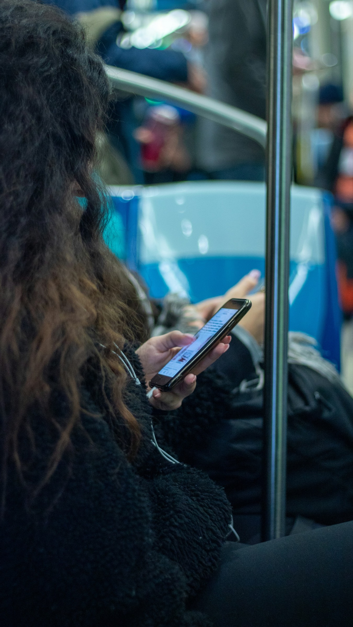 A professional captures a fresh career achievement on her phone during the commute home